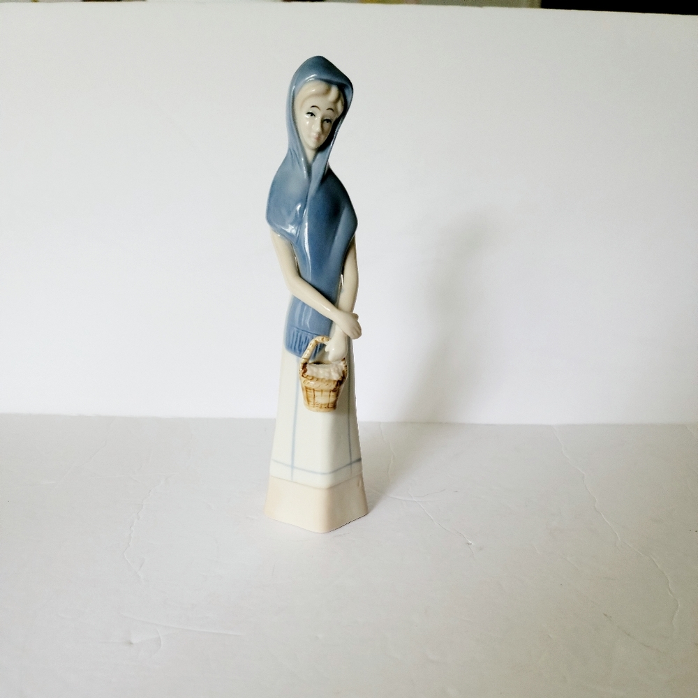 Porcelain figurine lady carrying basket blue off white